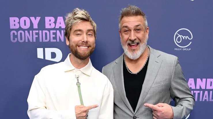 Two attendees at a Boy Band Confidential premiere event